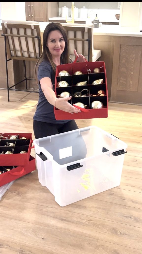 Lori Cela organizing holiday ornaments into labeled storage bins